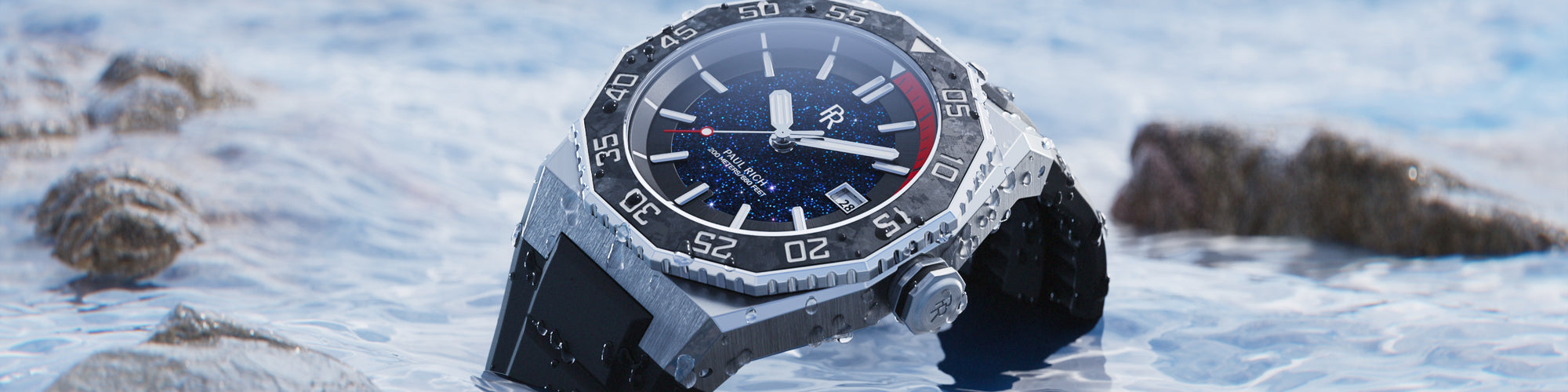 Paul Rich dive-style watch with black bezel and aventurine dial, resting in shallow water among rocks, partially covered in droplets. Paul Rich dive-style watch with black bezel and aventurine dial, resting in shallow water among rocks, partially covered in droplets.
