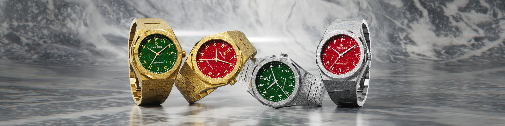 Paul Rich frosted gold and silver watches with green and red dials, displayed on polished marble surface with misty gray backdrop. Paul Rich frosted gold and silver watches with green and red dials, displayed on polished marble surface with misty gray backdrop.