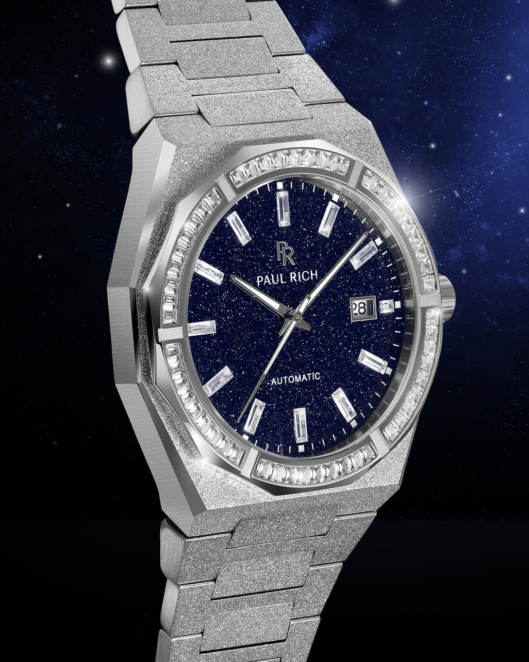Silver frosted watch with blue aventurine dial, moissanite bezel, and date window shown at an angle against a deep starry background. Silver frosted watch with blue aventurine dial, moissanite bezel, and date window shown at an angle against a deep starry background.