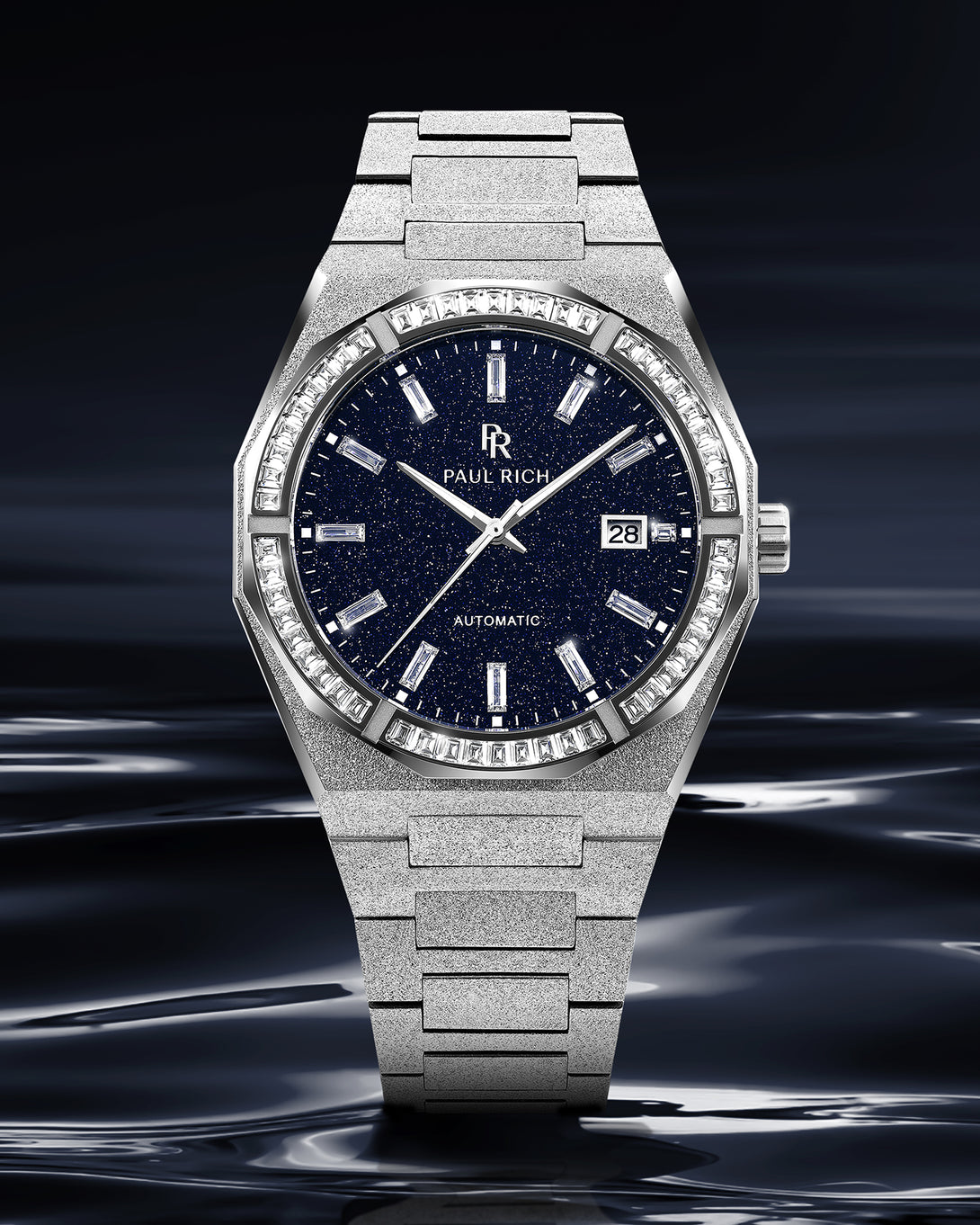 Silver frosted watch with blue aventurine dial and moissanite bezel shown upright against a dark reflective background resembling liquid metal. Silver frosted watch with blue aventurine dial and moissanite bezel shown upright against a dark reflective background resembling liquid metal.