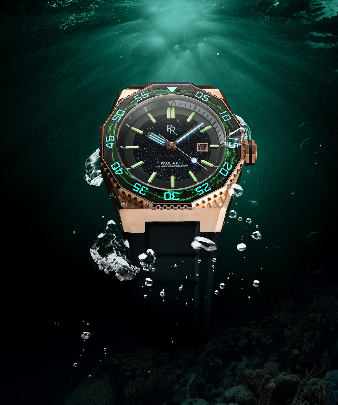 Paul Rich watch with rose gold case, blue aventurine dial, and glowing green markers submerged underwater with air bubbles rising around it. Paul Rich watch with rose gold case, blue aventurine dial, and glowing green markers submerged underwater with air bubbles rising around it.
