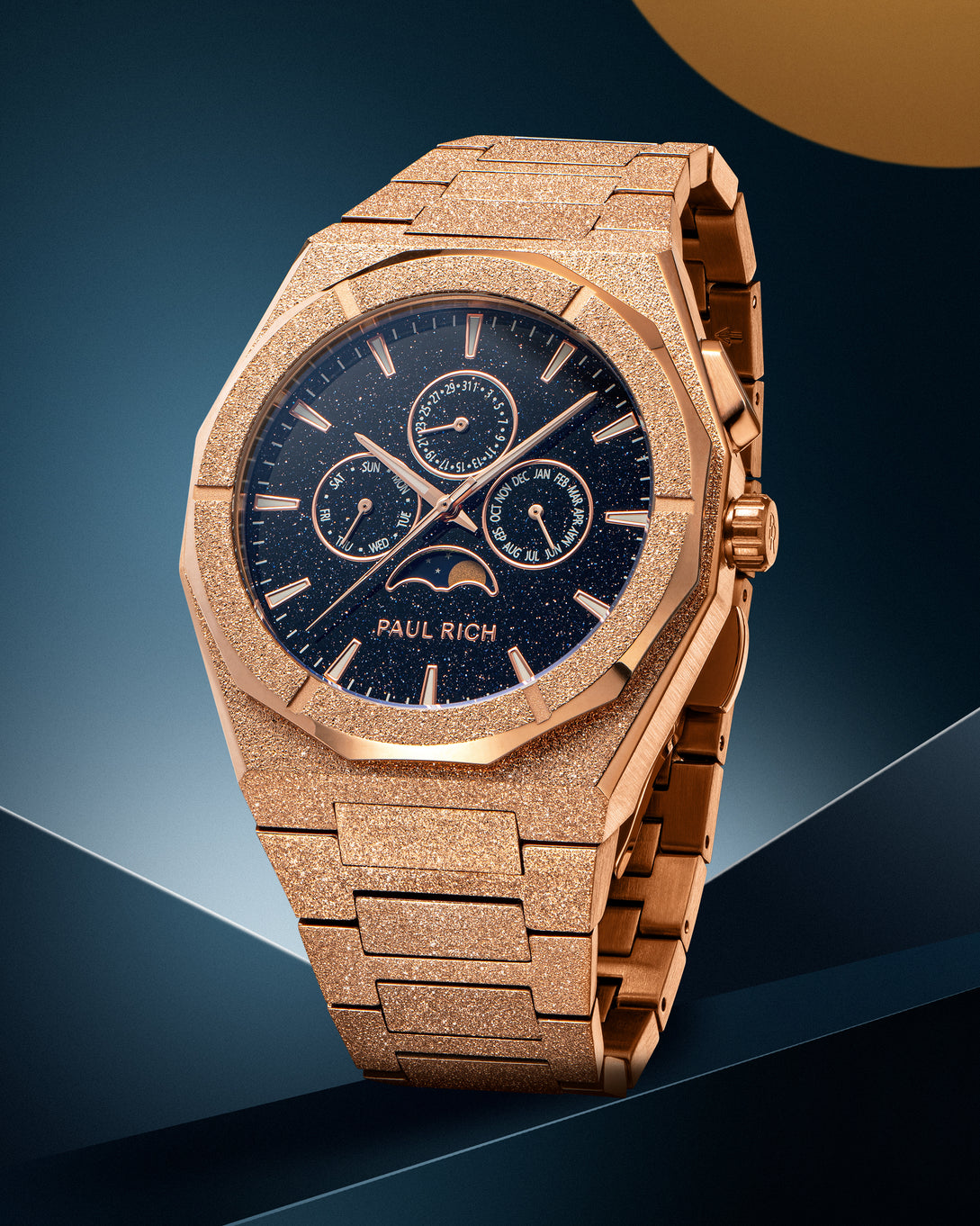 Frosted roseβgold moonphase watch with aventurine dial and dayβdateβmonth subdials, on a matching frosted roseβgold bracelet. Frosted roseβgold moonphase watch with aventurine dial and dayβdateβmonth subdials, on a matching frosted roseβgold bracelet.