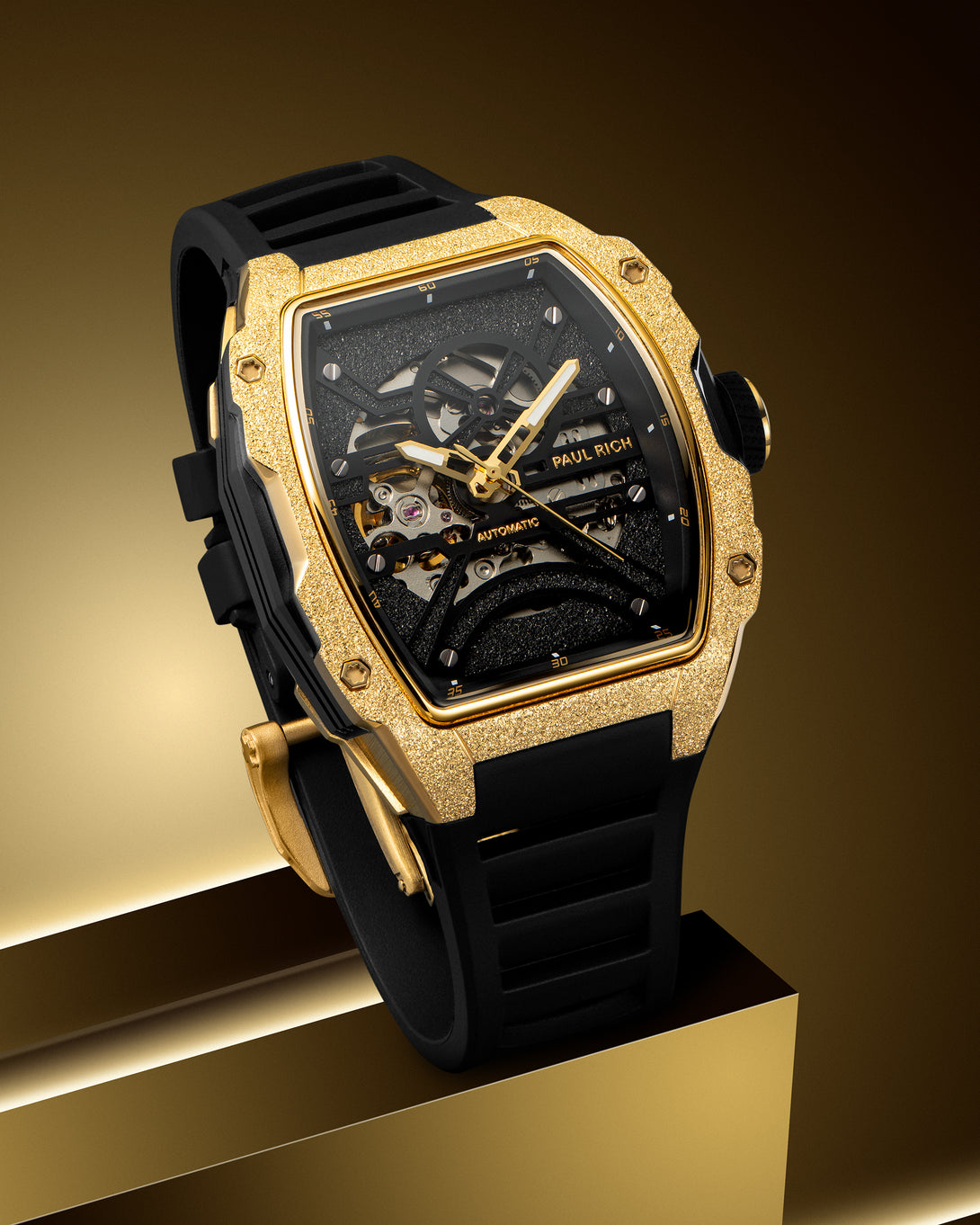 Gold frosted tonneau case watch with open skeleton dial and black strap. Gold frosted tonneau case watch with open skeleton dial and black strap.