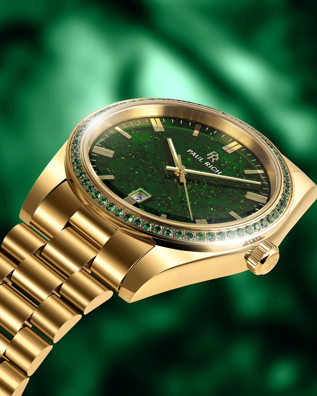 Gold watch with green aventurine dial and green gemstone-set bezel on a gold bracelet, shown at an angle against a green background. Gold watch with green aventurine dial and green gemstone-set bezel on a gold bracelet, shown at an angle against a green background.