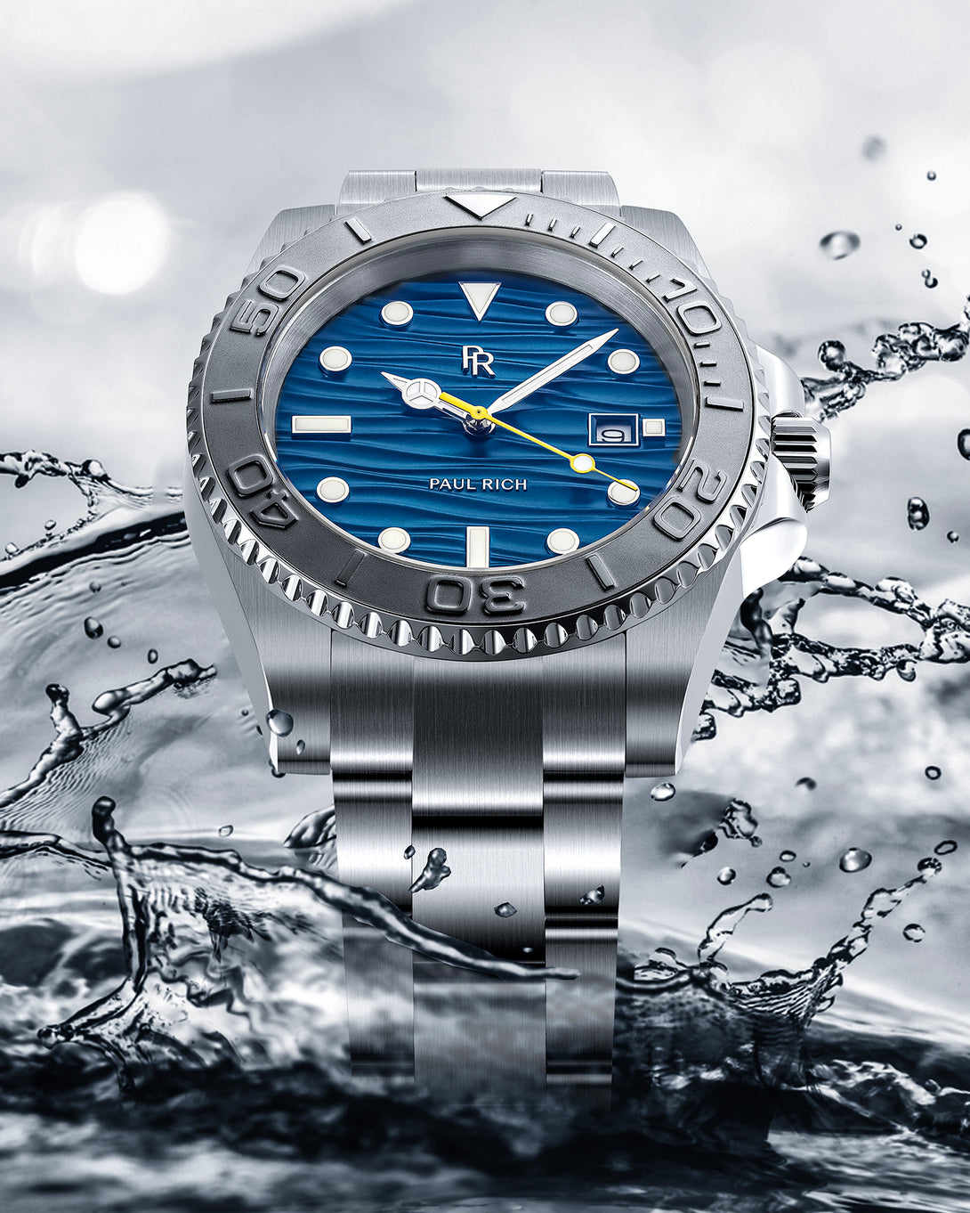 Stainless steel watch with a blue wave-textured dial shown against splashing water, highlighting the bezel, bracelet, and yellow seconds hand. Stainless steel watch with a blue wave-textured dial shown against splashing water, highlighting the bezel, bracelet, and yellow seconds hand.