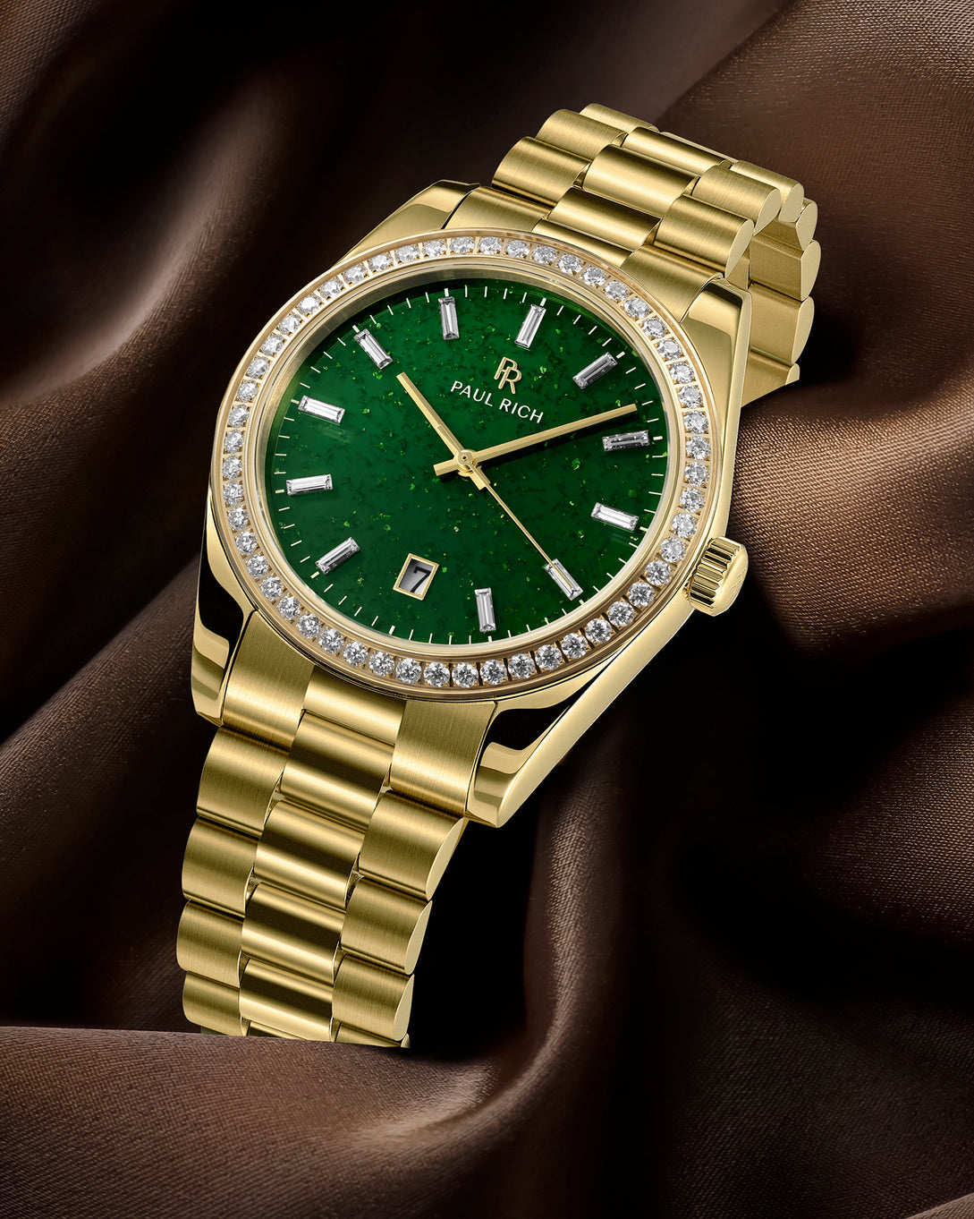 Gold watch with a green face on a brown fabric background Gold watch with a green face on a brown fabric background