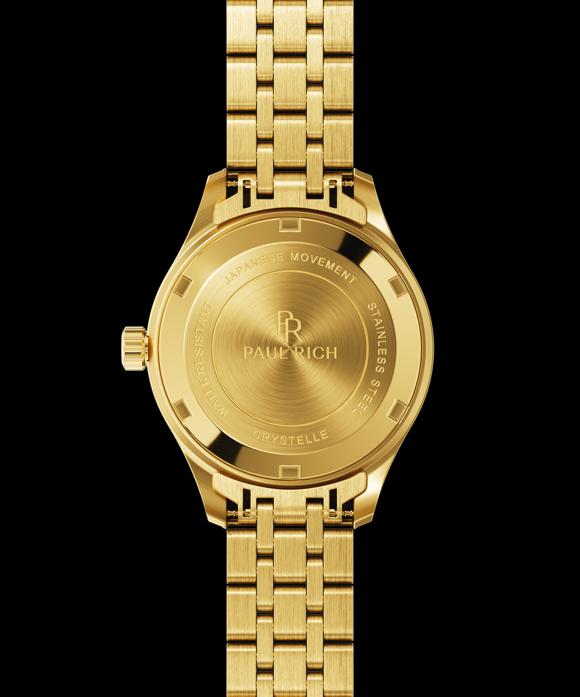Back view of a gold-tone Paul Rich watch showing an engraved caseback with the text “Paul Rich,” “Japanese Movement,” “Stainless Steel,” “Water Resistant,” and “Crystelle.” Back view of a gold-tone Paul Rich watch showing an engraved caseback with the text “Paul Rich,” “Japanese Movement,” “Stainless Steel,” “Water Resistant,” and “Crystelle.”
