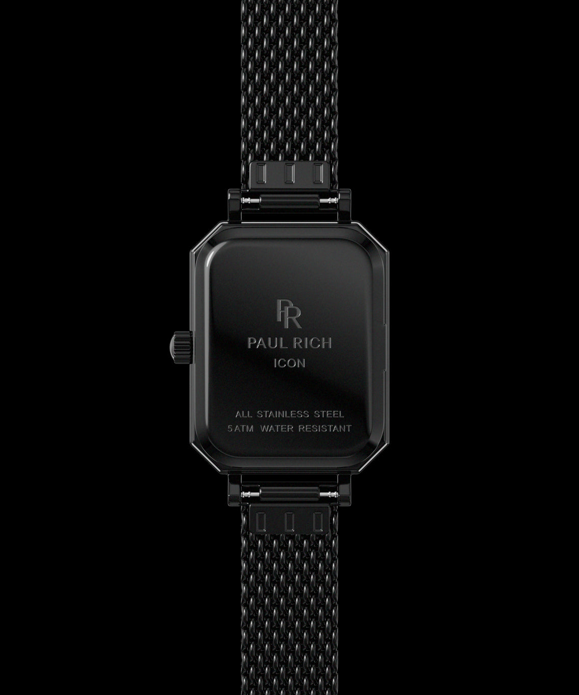 Back view of a black Paul Rich watch with rectangular case engraved with βPaul Rich ICON,β βAll Stainless Steel,β and β5ATM Water Resistant,β shown with a black mesh strap. Back view of a black Paul Rich watch with rectangular case engraved with βPaul Rich ICON,β βAll Stainless Steel,β and β5ATM Water Resistant,β shown with a black mesh strap.