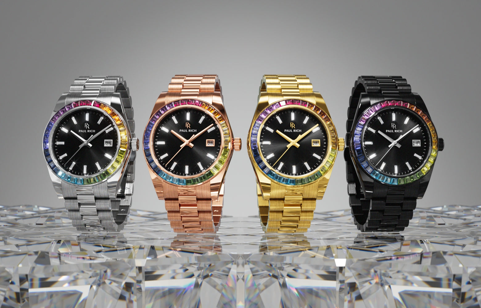 Four Paul Rich rainbow bezel watches in silver, rose gold, gold, and black with black dials, displayed on faceted crystal surface. Four Paul Rich rainbow bezel watches in silver, rose gold, gold, and black with black dials, displayed on faceted crystal surface.