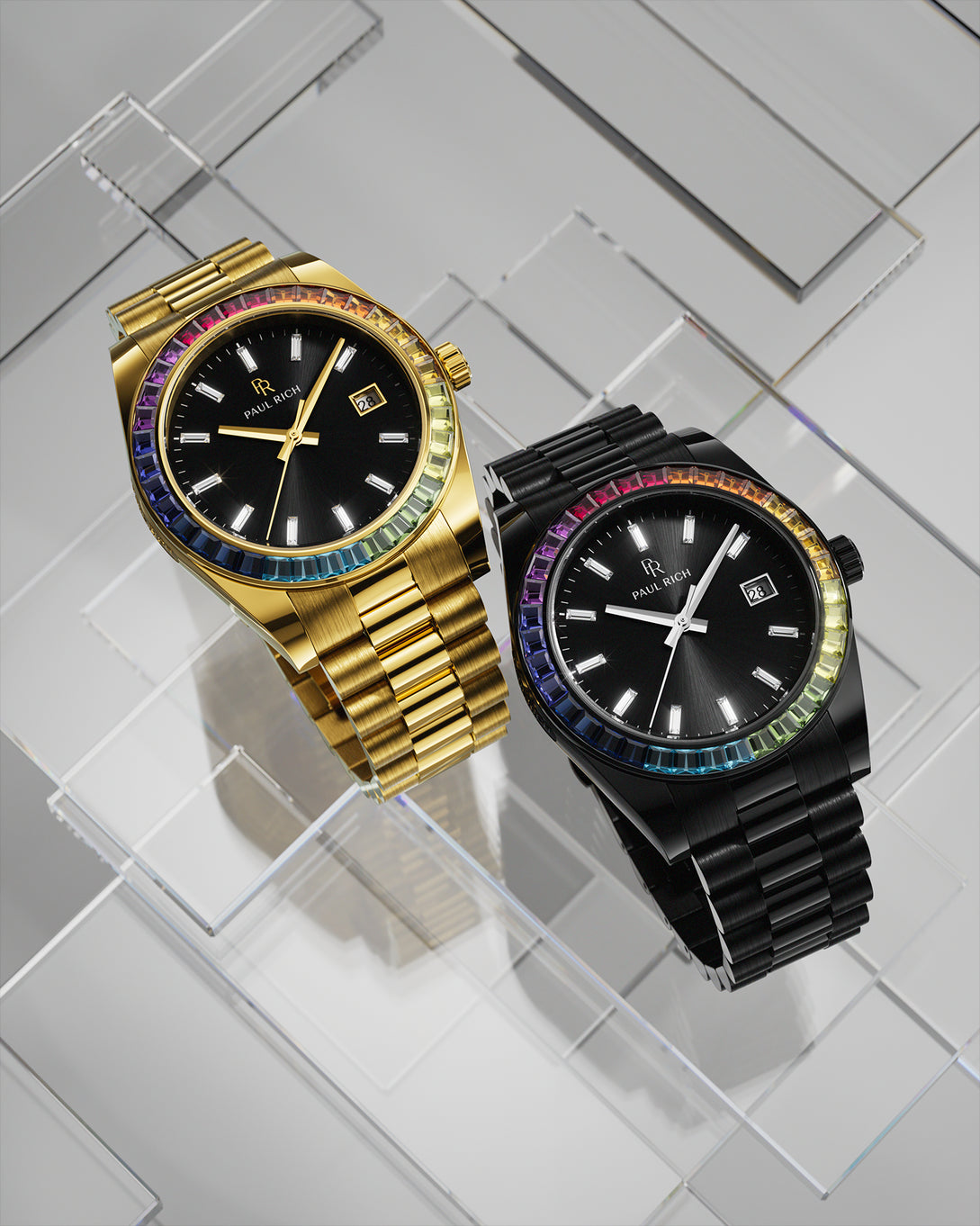 Gold and black wristwatches with black sunburst dials and rainbow bezels displayed side by side on a reflective geometric glass surface. Gold and black wristwatches with black sunburst dials and rainbow bezels displayed side by side on a reflective geometric glass surface.