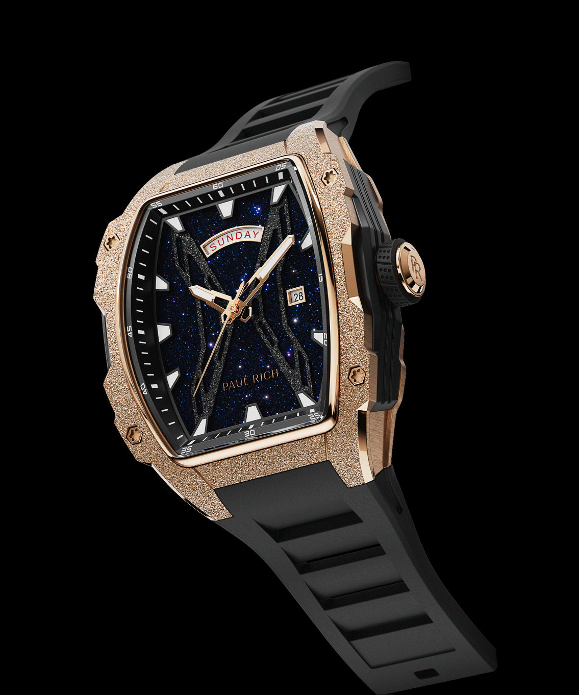 Angled view of Paul Rich watch with frosted rose gold tonneau case, blue aventurine dial, day-date display, and black rubber strap. Angled view of Paul Rich watch with frosted rose gold tonneau case, blue aventurine dial, day-date display, and black rubber strap.