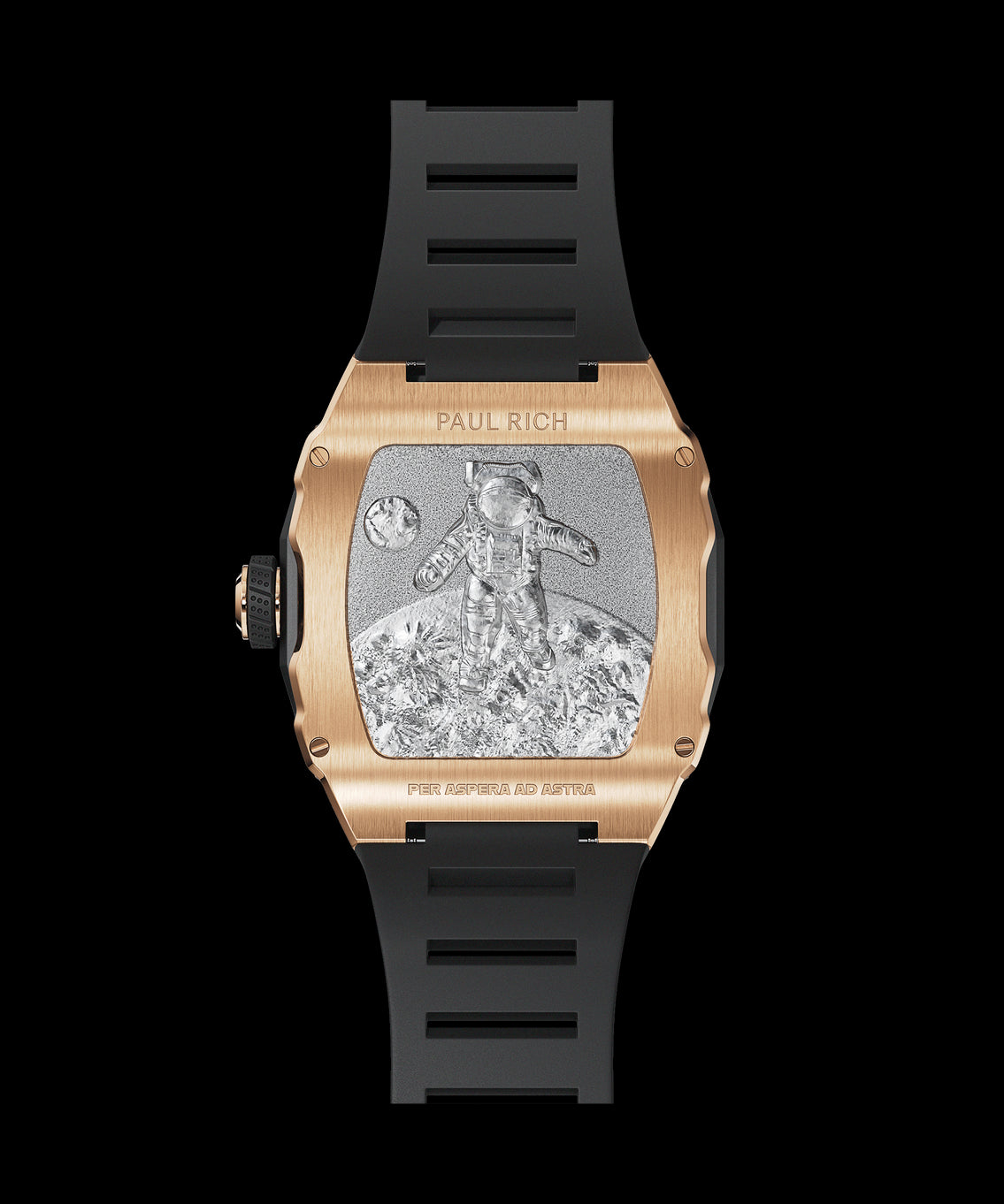 Back view of a Paul Rich rose gold-tonneau watch with engraved astronaut on the moon, “PER ASPERA AD ASTRA” inscription, and black rubber strap. Back view of a Paul Rich rose gold-tonneau watch with engraved astronaut on the moon, “PER ASPERA AD ASTRA” inscription, and black rubber strap.