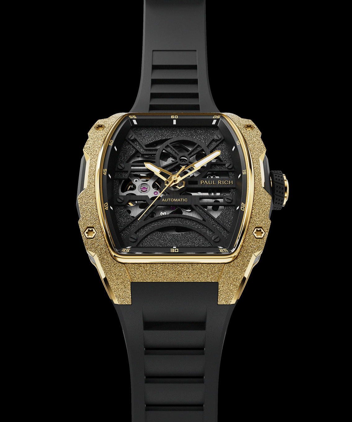 Front view of Paul Rich watch with frosted gold tonneau case, gold hands, black skeleton dial, and black rubber strap, shown vertically. Front view of Paul Rich watch with frosted gold tonneau case, gold hands, black skeleton dial, and black rubber strap, shown vertically.