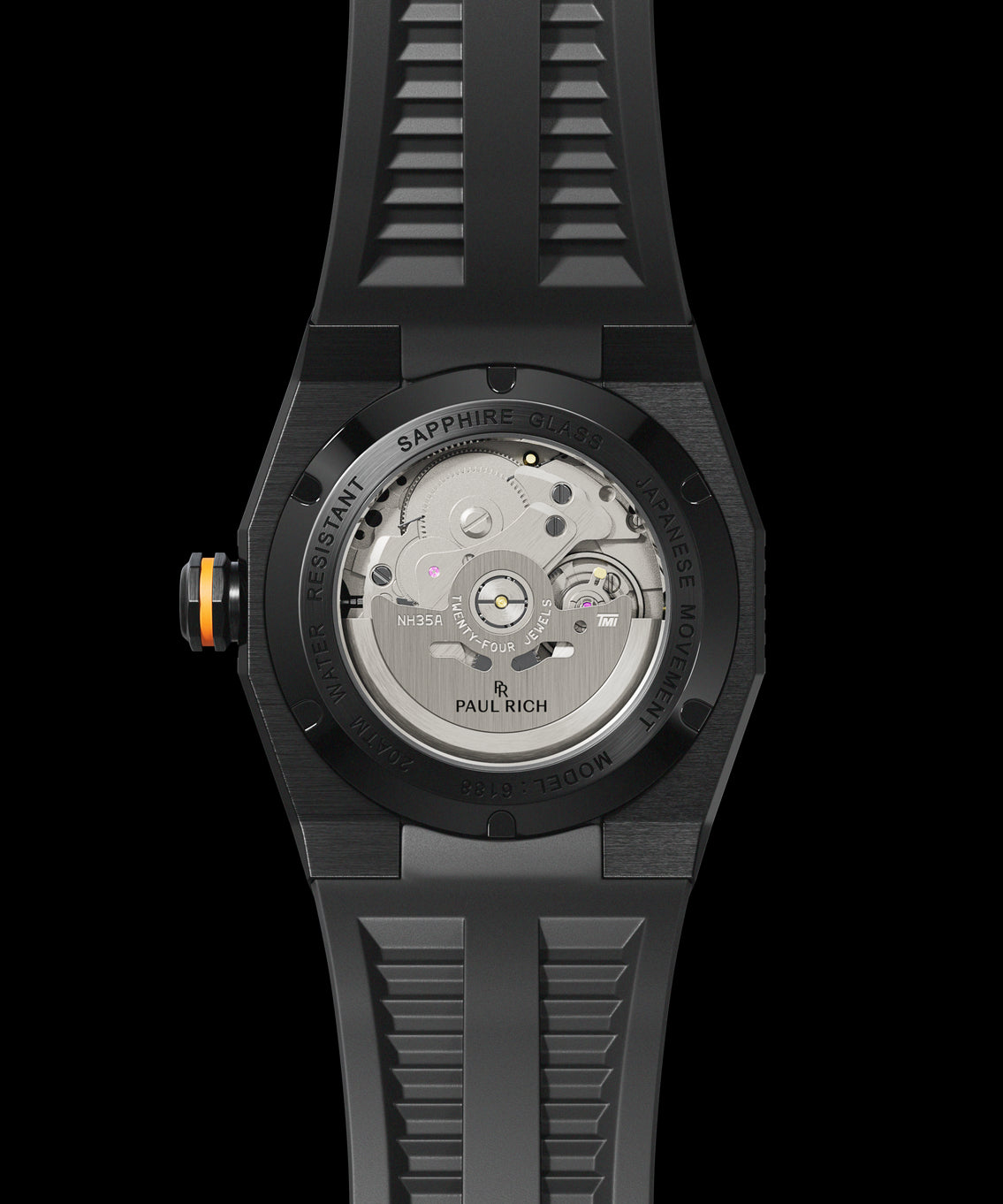 Back view of a Paul Rich dive watch with black case, sapphire exhibition caseback revealing NH35A movement, and orange crown ring. Back view of a Paul Rich dive watch with black case, sapphire exhibition caseback revealing NH35A movement, and orange crown ring.