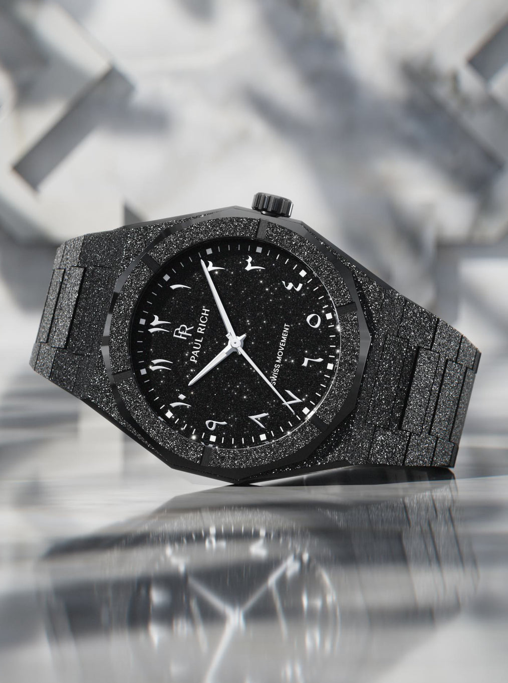 Paul Rich black frosted watch with black aventurine dial, silver Eastern Arabic numerals, and Swiss movement on black bracelet. Paul Rich black frosted watch with black aventurine dial, silver Eastern Arabic numerals, and Swiss movement on black bracelet.