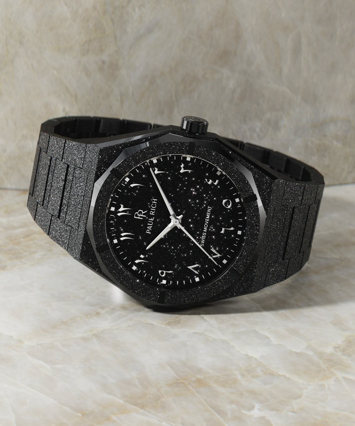 Paul Rich black frosted watch with black aventurine dial and silver Eastern Arabic numerals, displayed horizontally on marble surface. Paul Rich black frosted watch with black aventurine dial and silver Eastern Arabic numerals, displayed horizontally on marble surface.