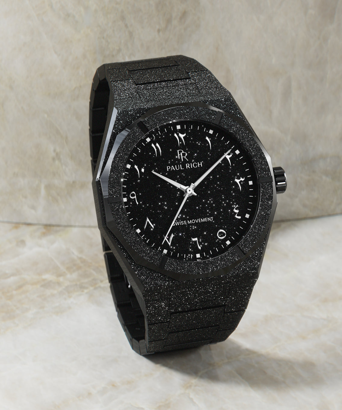 Paul Rich black frosted watch with black aventurine dial, silver Eastern Arabic numerals, and Swiss movement, standing upright on marble. Paul Rich black frosted watch with black aventurine dial, silver Eastern Arabic numerals, and Swiss movement, standing upright on marble.