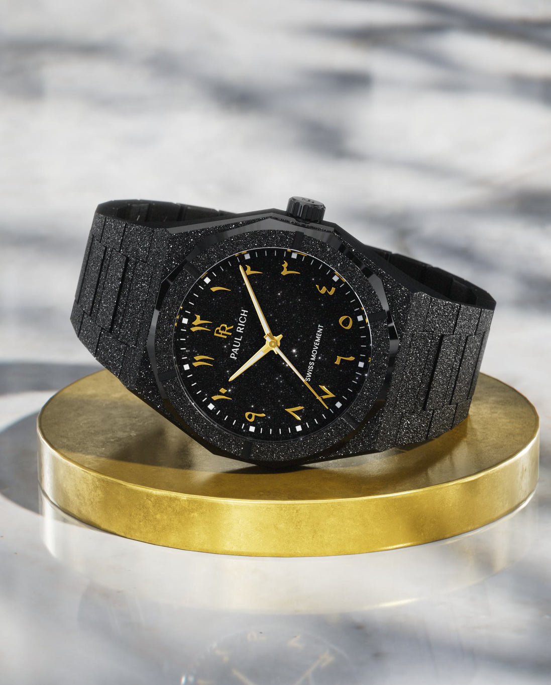 Paul Rich black frosted watch with black aventurine dial, gold Eastern Arabic numerals, and Swiss movement on black bracelet. Paul Rich black frosted watch with black aventurine dial, gold Eastern Arabic numerals, and Swiss movement on black bracelet.