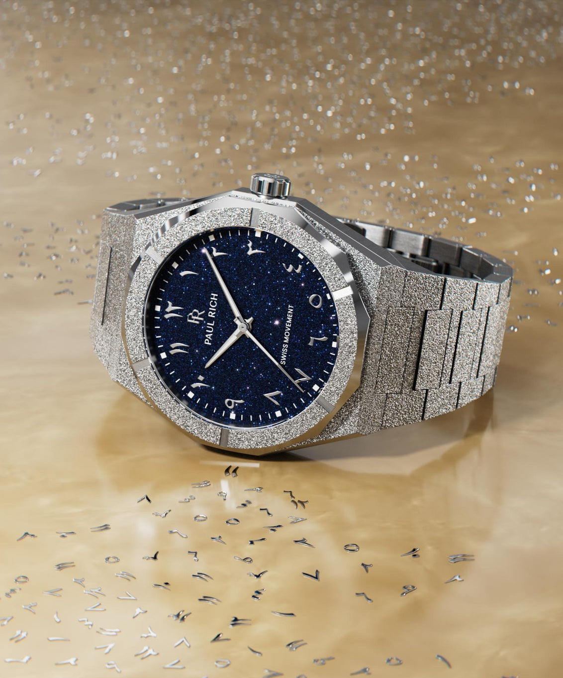 Frosted silver watch with a blue aventurine dial and Arabic numerals, displayed on a reflective ivory surface with scattered metallic markers. Frosted silver watch with a blue aventurine dial and Arabic numerals, displayed on a reflective ivory surface with scattered metallic markers.