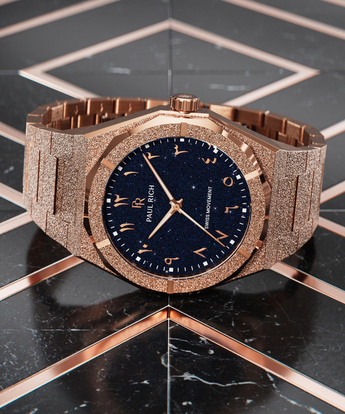 Frosted rose gold watch with a blue aventurine dial and Arabic numerals, laid flat on a glossy black and rose gold geometric surface. Frosted rose gold watch with a blue aventurine dial and Arabic numerals, laid flat on a glossy black and rose gold geometric surface.