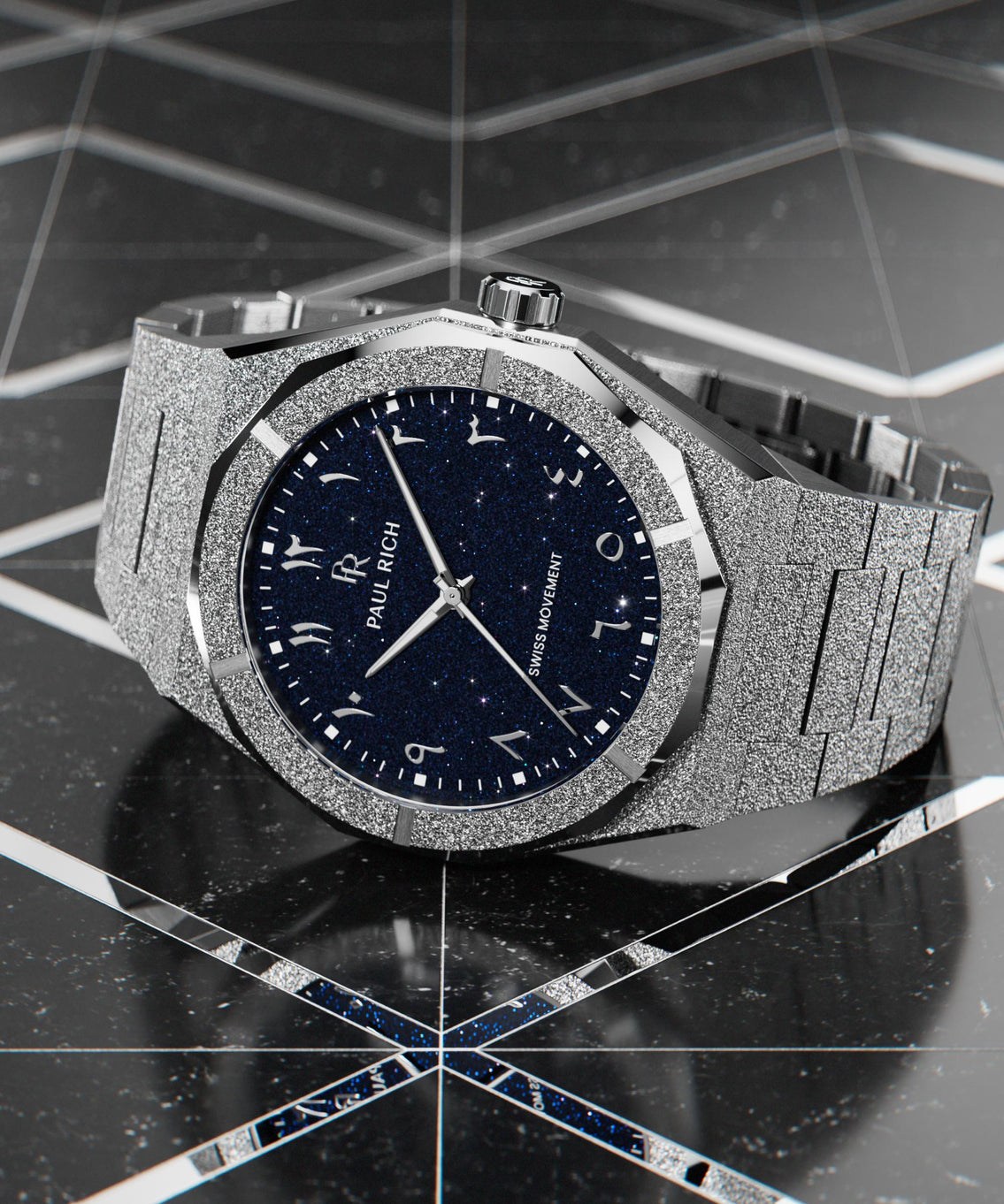 Frosted silver watch with a blue aventurine dial and Arabic numerals, displayed on a glossy black geometric surface with mirrored accents. Frosted silver watch with a blue aventurine dial and Arabic numerals, displayed on a glossy black geometric surface with mirrored accents.