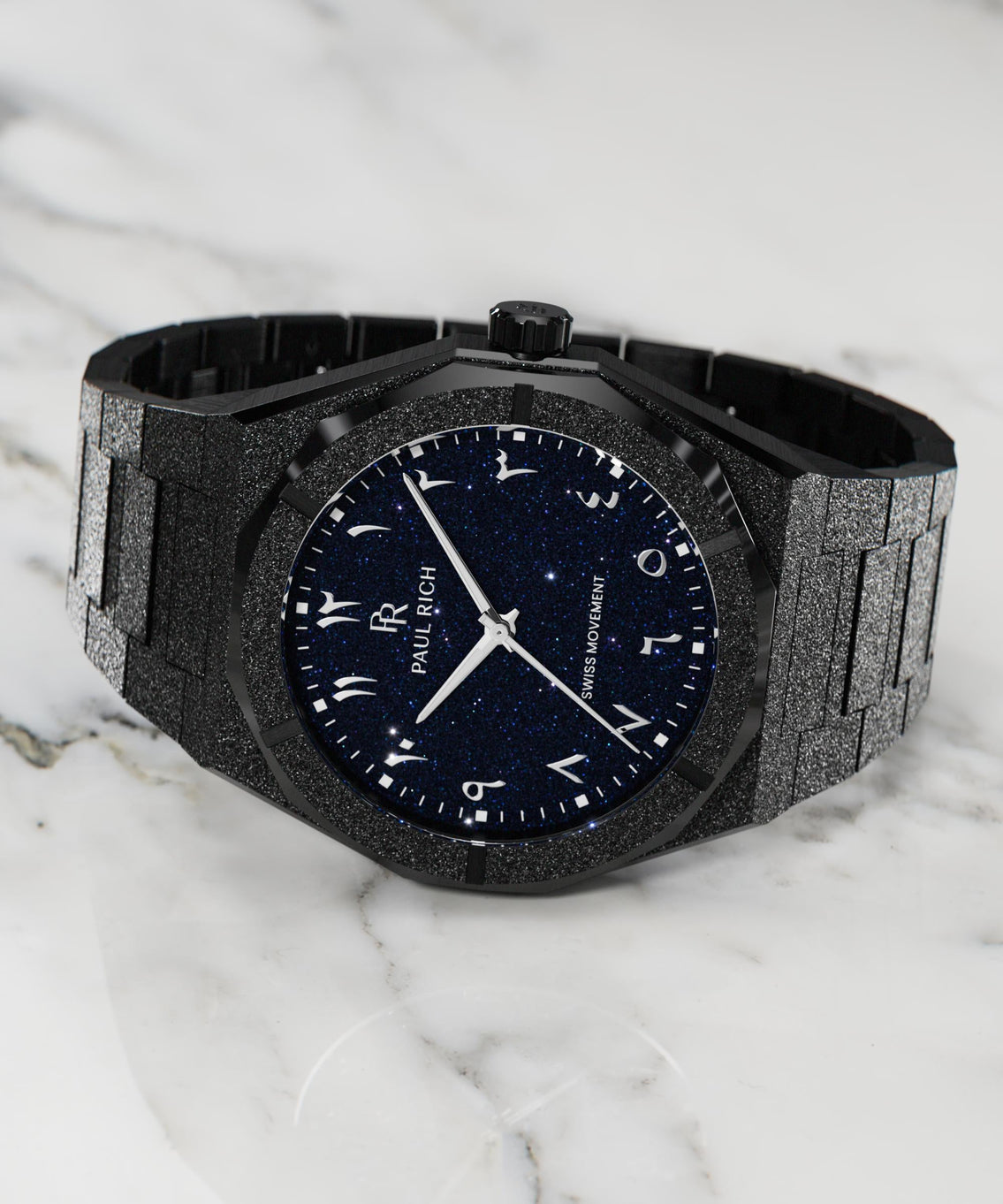 Frosted black watch with blue aventurine dial and Arabic numerals, displayed on a white marble surface. Frosted black watch with blue aventurine dial and Arabic numerals, displayed on a white marble surface.