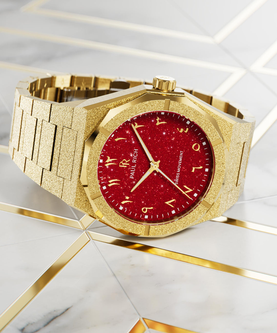 Paul Rich watch with frosted gold case and red aventurine dial with Arabic numerals, displayed on a marble and gold geometric surface. Paul Rich watch with frosted gold case and red aventurine dial with Arabic numerals, displayed on a marble and gold geometric surface.