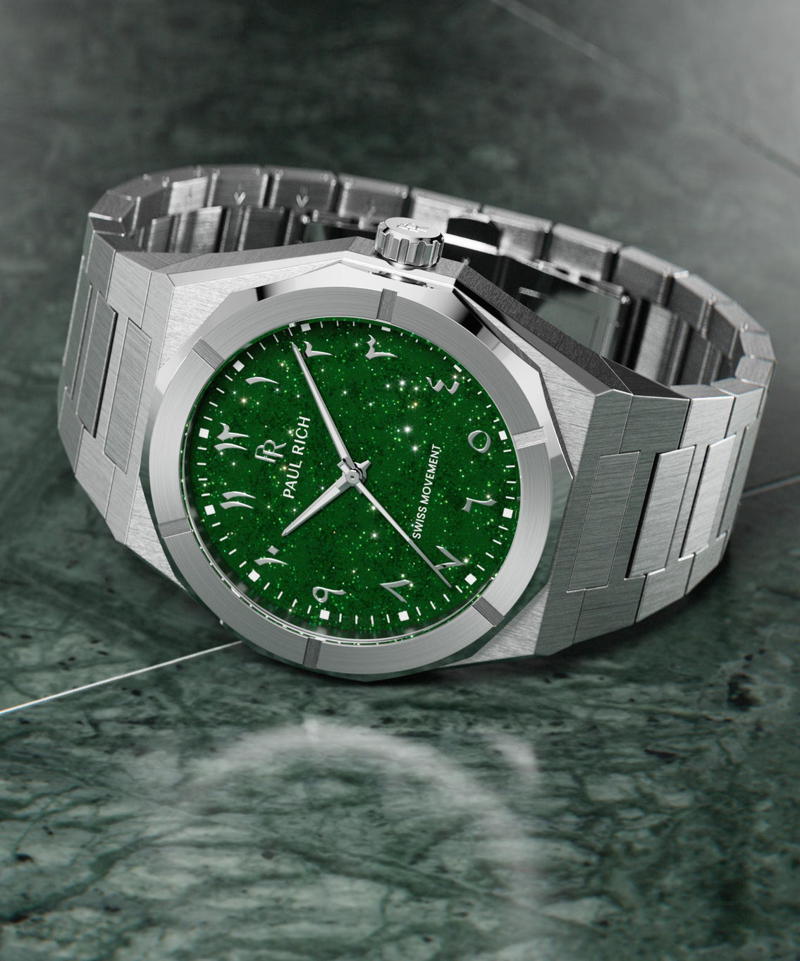 Paul Rich watch with brushed silver case and sparkling green dial with Arabic numerals, displayed on a polished green marble surface. Paul Rich watch with brushed silver case and sparkling green dial with Arabic numerals, displayed on a polished green marble surface.