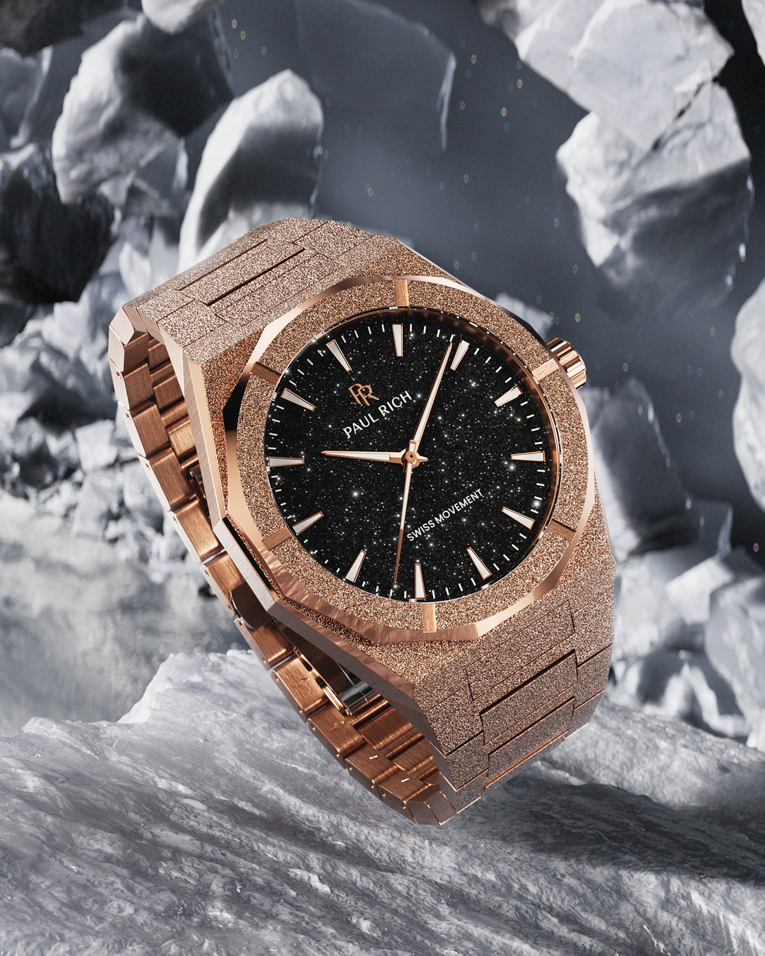 Rose gold Paul Rich watch with fully frosted case and bracelet, black aventurine dial, rose gold markers and hands, and labeled “Swiss Movement,” displayed on a rugged icy surface with floating asteroid-like rocks in the background. Rose gold Paul Rich watch with fully frosted case and bracelet, black aventurine dial, rose gold markers and hands, and labeled “Swiss Movement,” displayed on a rugged icy surface with floating asteroid-like rocks in the background.