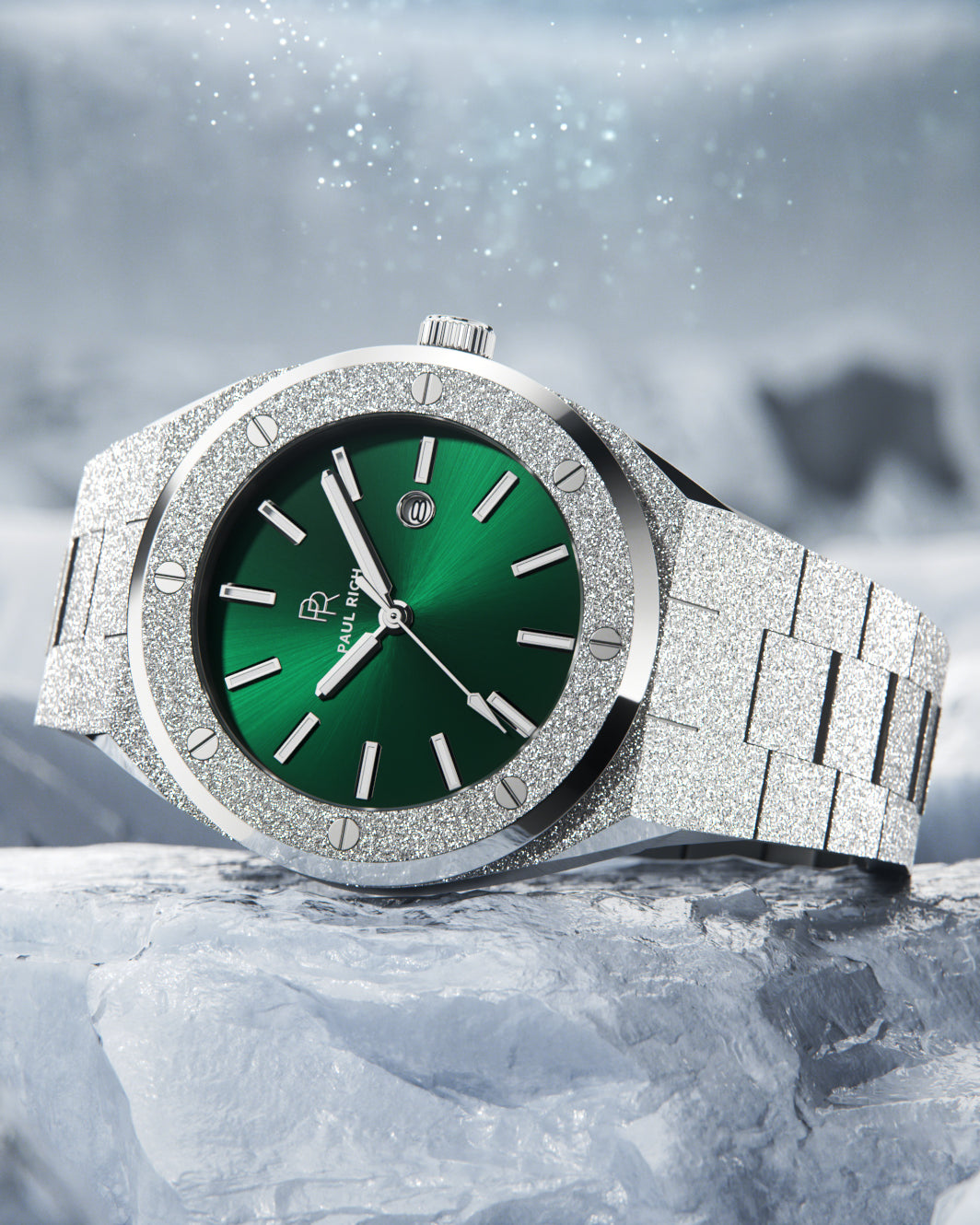 Paul Rich frosted silver watch with green sunray dial and silver markers, resting on icy rock with snow and sparkles in the background. Paul Rich frosted silver watch with green sunray dial and silver markers, resting on icy rock with snow and sparkles in the background.