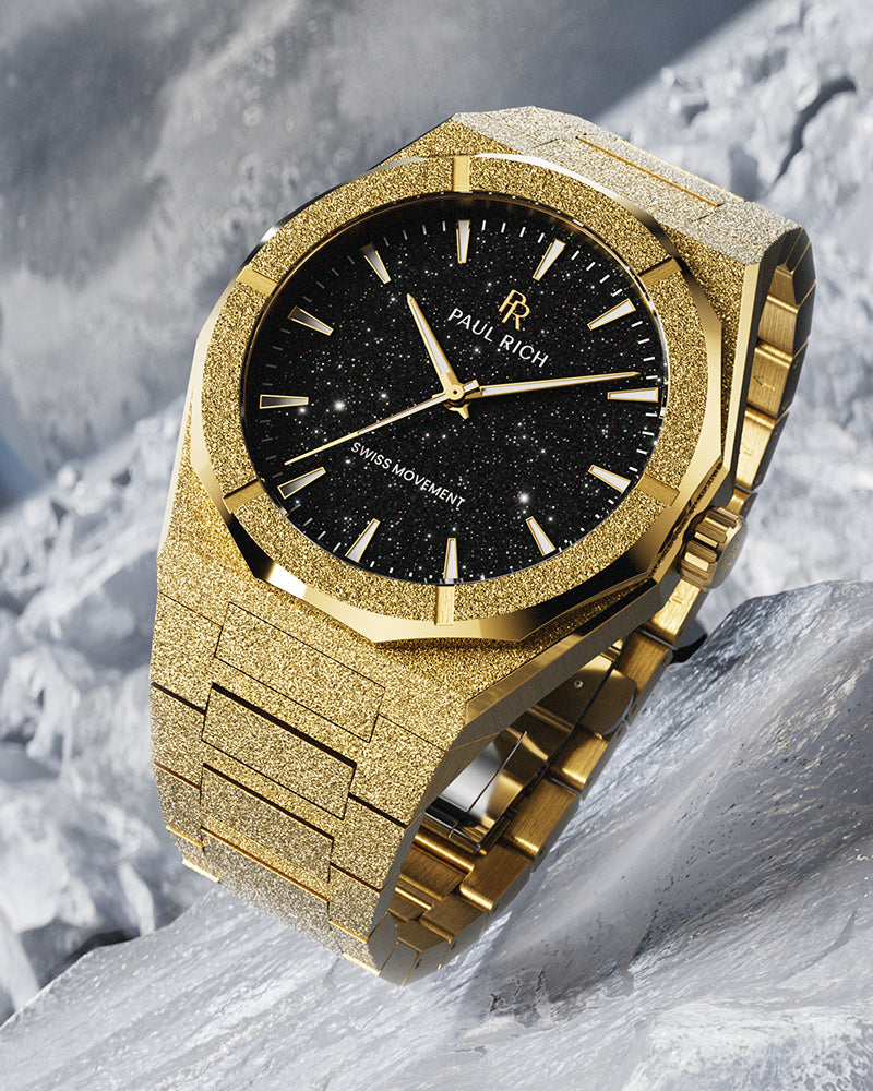 Gold Paul Rich watch with frosted finish and black aventurine dial, displayed on a textured icy surface with dramatic lighting. Gold Paul Rich watch with frosted finish and black aventurine dial, displayed on a textured icy surface with dramatic lighting.