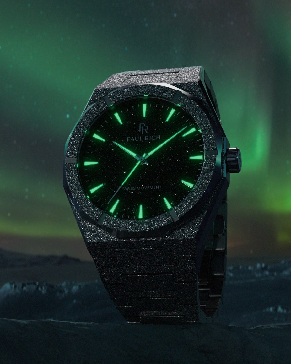 Paul Rich watch with frosted black case and green-glowing markers, set against an aurora-lit night sky and icy terrain. Paul Rich watch with frosted black case and green-glowing markers, set against an aurora-lit night sky and icy terrain.