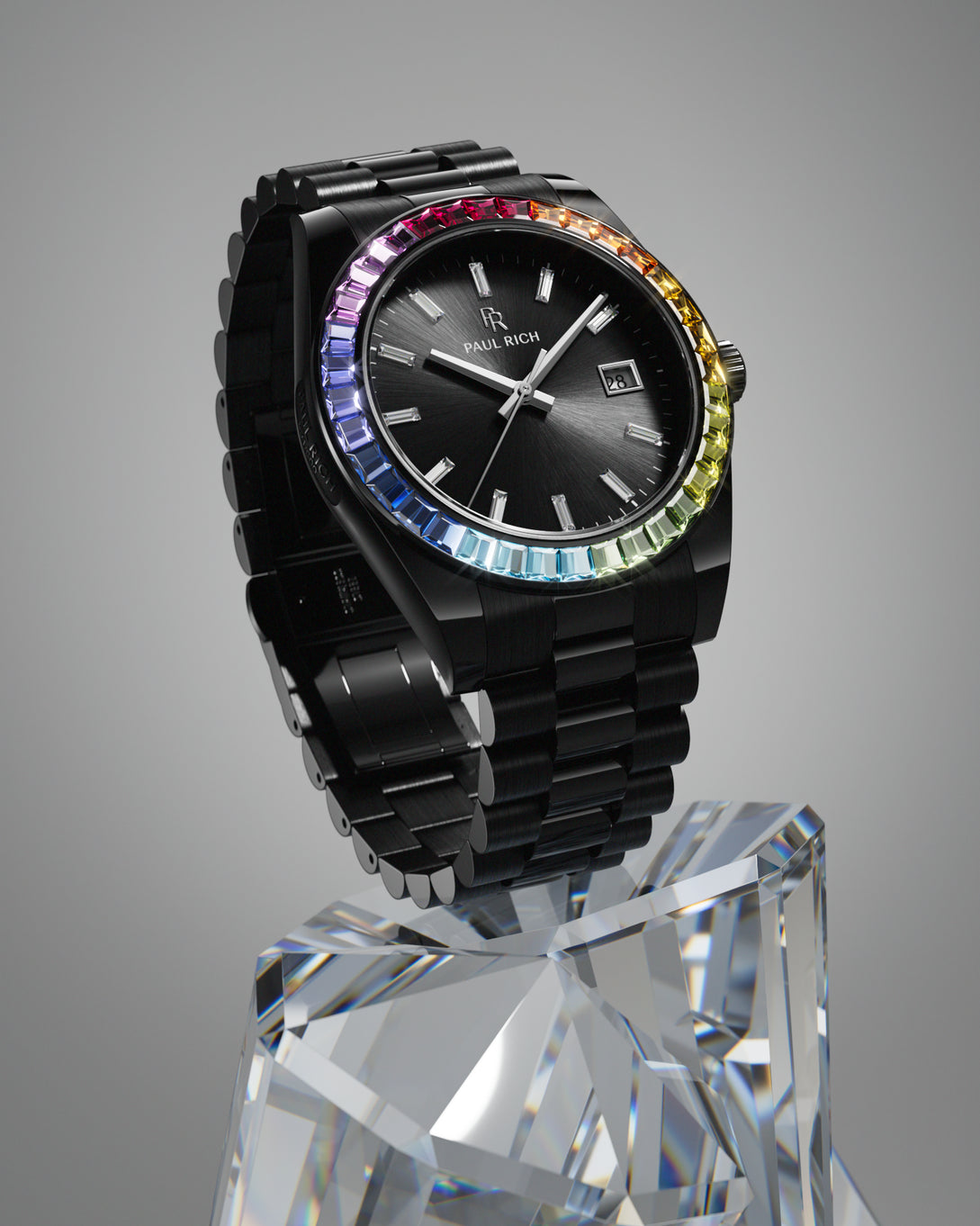 Black wristwatch with a dark sunburst dial, rainbow bezel, and black metal bracelet displayed upright on a large clear crystal pedestal. Black wristwatch with a dark sunburst dial, rainbow bezel, and black metal bracelet displayed upright on a large clear crystal pedestal.
