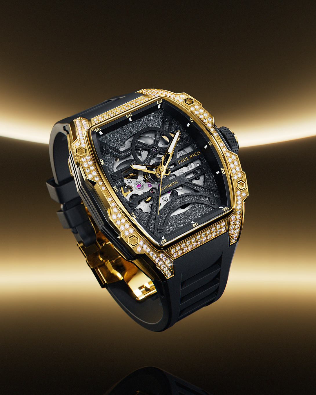 Angled view of a gold tonneau-shaped wristwatch with skeleton dial, crystal-set bezel, black textured baseplate, and black rubber strap on a transparent background. Angled view of a gold tonneau-shaped wristwatch with skeleton dial, crystal-set bezel, black textured baseplate, and black rubber strap on a transparent background.
