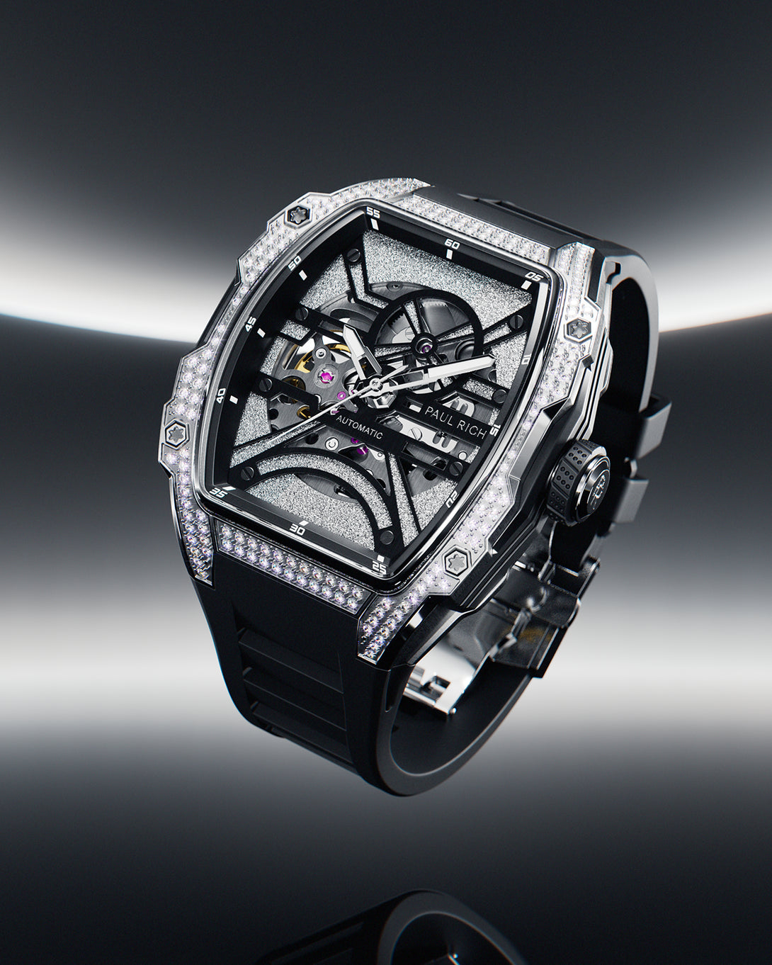 Tonneau-shaped wristwatch with skeleton dial, crystal-set bezel, and black rubber strap displayed on a reflective surface with a dark gradient background. Tonneau-shaped wristwatch with skeleton dial, crystal-set bezel, and black rubber strap displayed on a reflective surface with a dark gradient background.