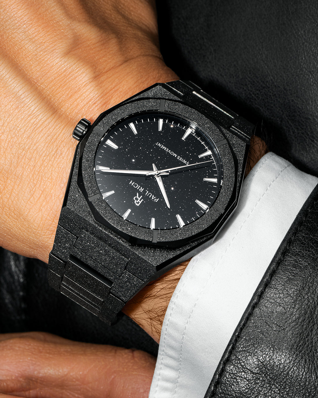 Paul Rich watch with frosted black case and black aventurine dial, worn with a white cuff and black leather jacket. Paul Rich watch with frosted black case and black aventurine dial, worn with a white cuff and black leather jacket.