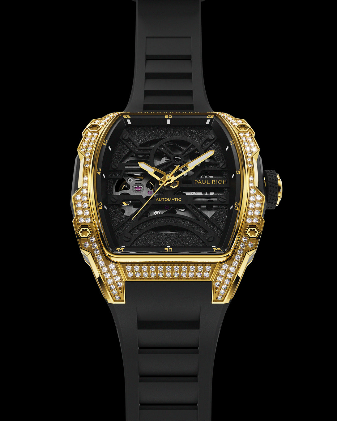 Gold tonneau-shaped wristwatch with skeleton dial, crystal-set bezel, black textured baseplate, and black rubber strap shown vertically on a transparent background. Gold tonneau-shaped wristwatch with skeleton dial, crystal-set bezel, black textured baseplate, and black rubber strap shown vertically on a transparent background.