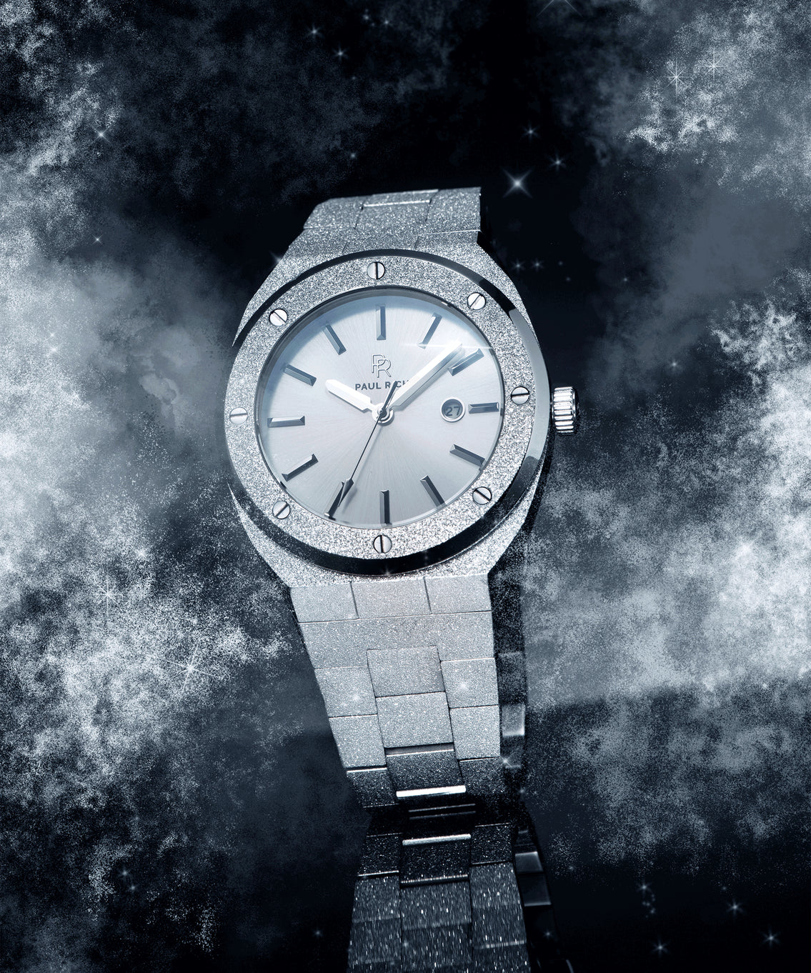 Paul Rich frosted silver watch with metallic dial and date window, shown at an angle against a cosmic background of stars and mist. Paul Rich frosted silver watch with metallic dial and date window, shown at an angle against a cosmic background of stars and mist.
