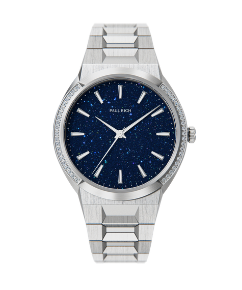 Cosmic Dust Silver Paul Rich watch with round case, blue aventurine dial, gem-set bezel, and brushed stainless steel bracelet, shown on transparent background.