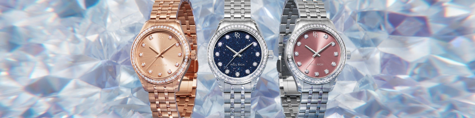 Paul Rich watches with gem-set bezels in rose gold and silver, featuring pink, blue, and silver dials, shown on a shimmering crystal background.