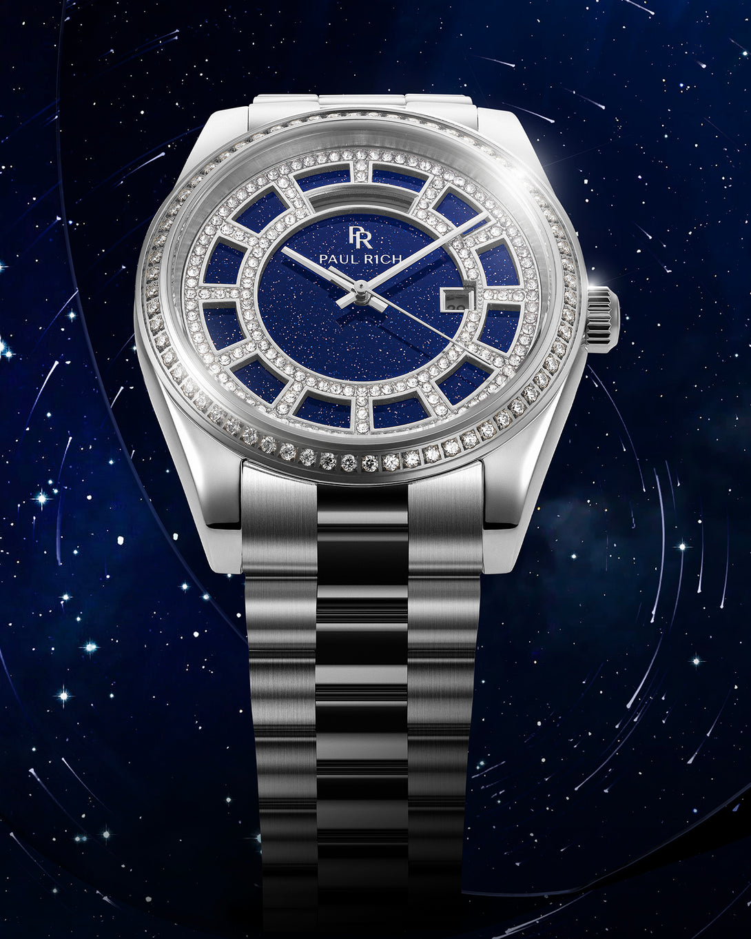 Silver watch with a blue aventurine dial, pavé diamond bezel, and steel bracelet shown against a deep blue star-filled background.