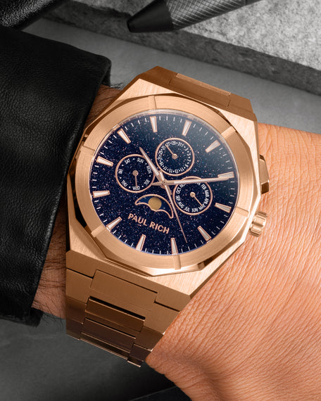 Rose gold moonphase watch on wrist with aventurine dial, calendar subdials, and brushed rose gold bracelet.
