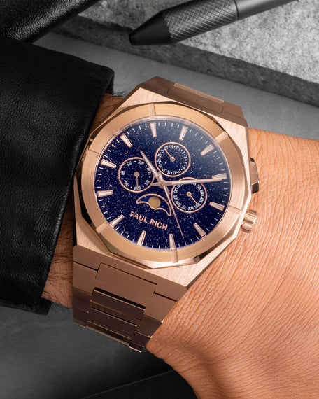 Rose gold moonphase watch on wrist with aventurine dial, calendar subdials, and brushed rose gold bracelet.