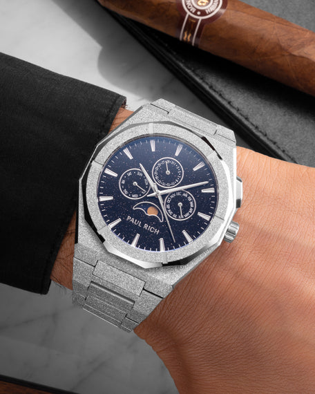 Frosted silver moonphase watch on wrist with aventurine dial, calendar subdials, and sparkling textured silver bracelet.