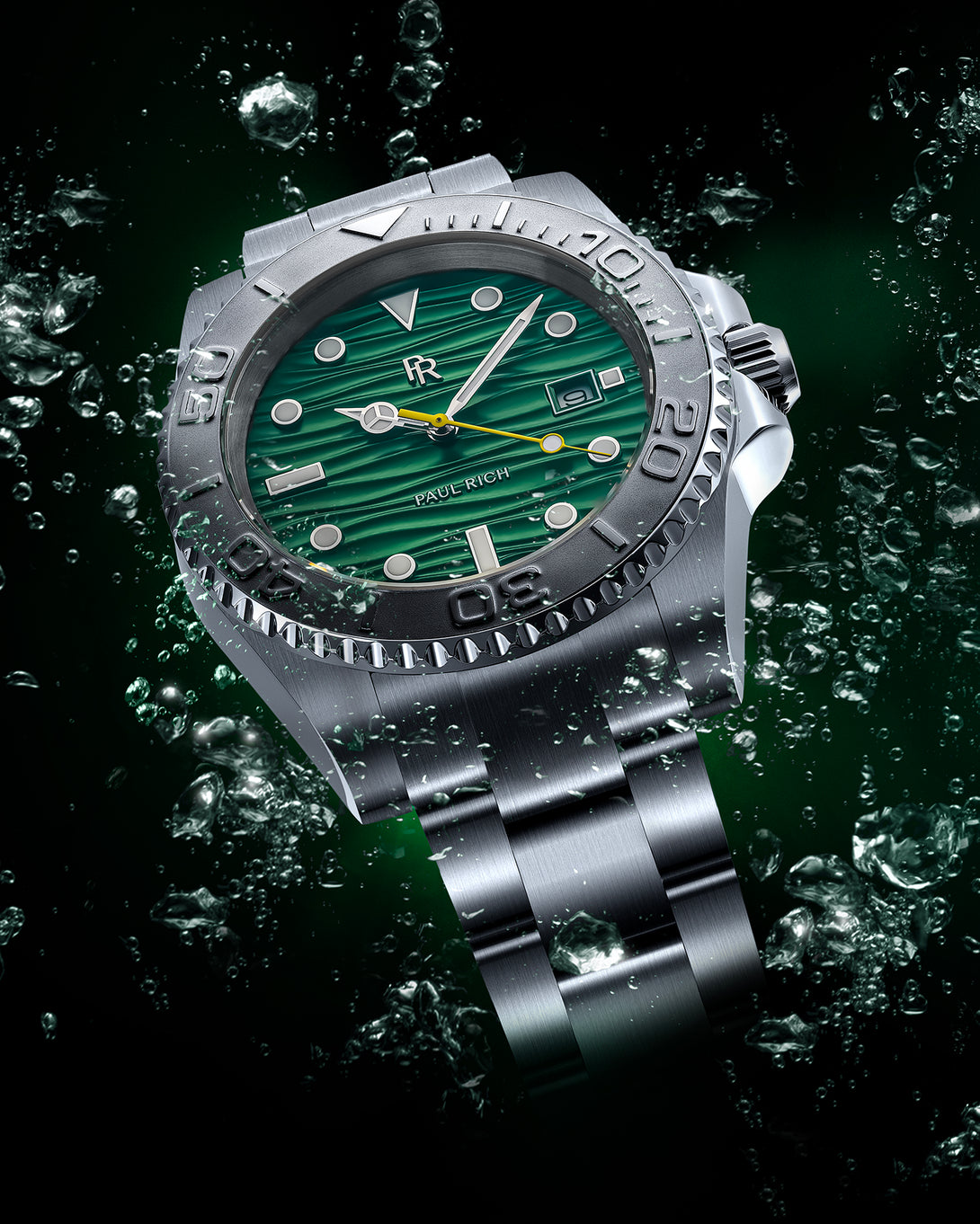 Stainless steel watch with a green wave-textured dial shown against splashing green-tinted water on a dark background, highlighting the bezel and bracelet.