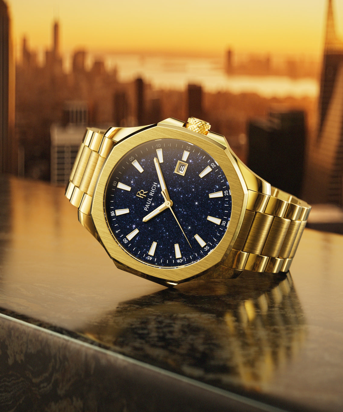 Paul Rich watch with brushed gold case and blue aventurine dial displayed on a rooftop ledge at golden hour, with NYC skyline in background.