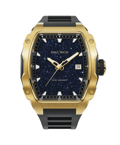 Front view of a Paul Rich gold-tonneau watch with blue aventurine dial, gold-tone hour, minute, and second hands, date window, and black rubber strap.