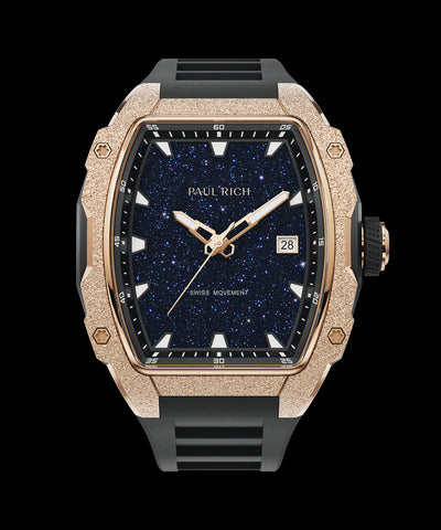 Front view of Paul Rich watch with blue aventurine dial, rose gold frosted bezel, date display, and black rubber strap.