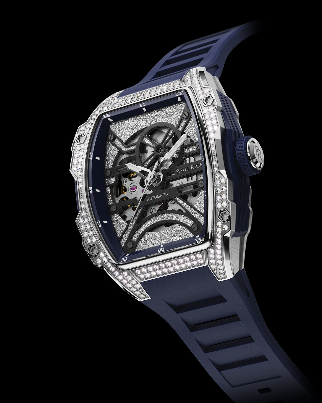 Angled view of open dial watch with diamond-set silver case and navy blue strap, shown on transparent background.