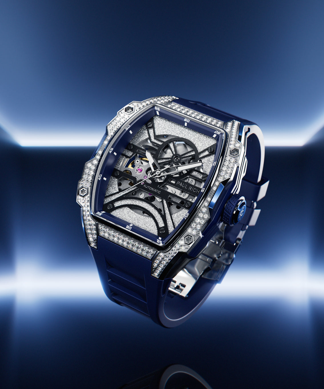 Angled view of open dial watch with diamond-set silver case and blue strap, shown on glowing blue gradient background.